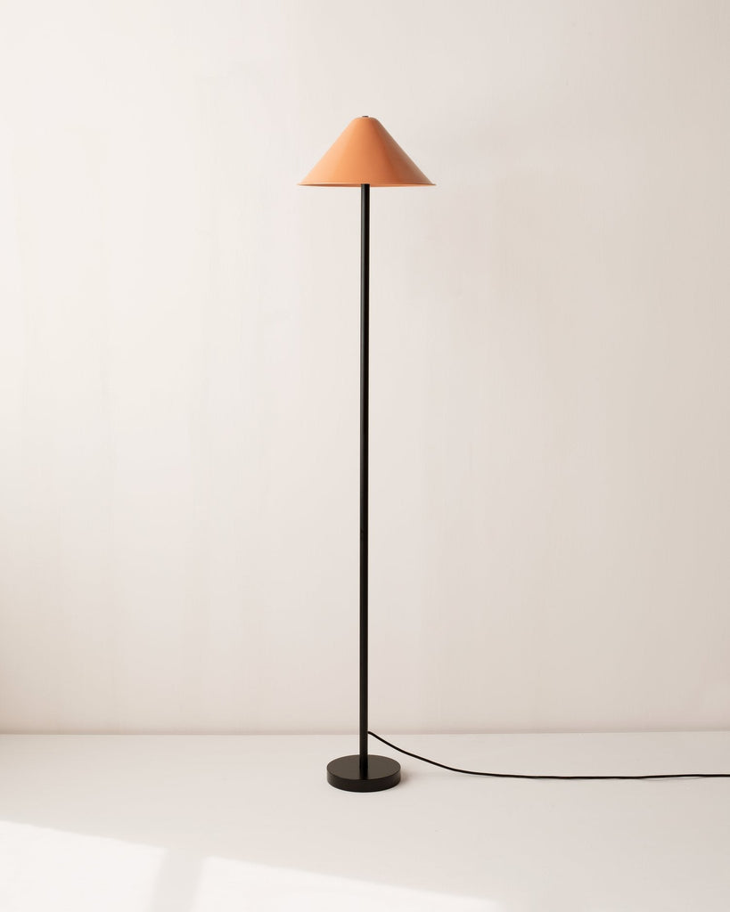 An orange shade and a black base IN COMMON WITH EAVE FLOOR LAMP.