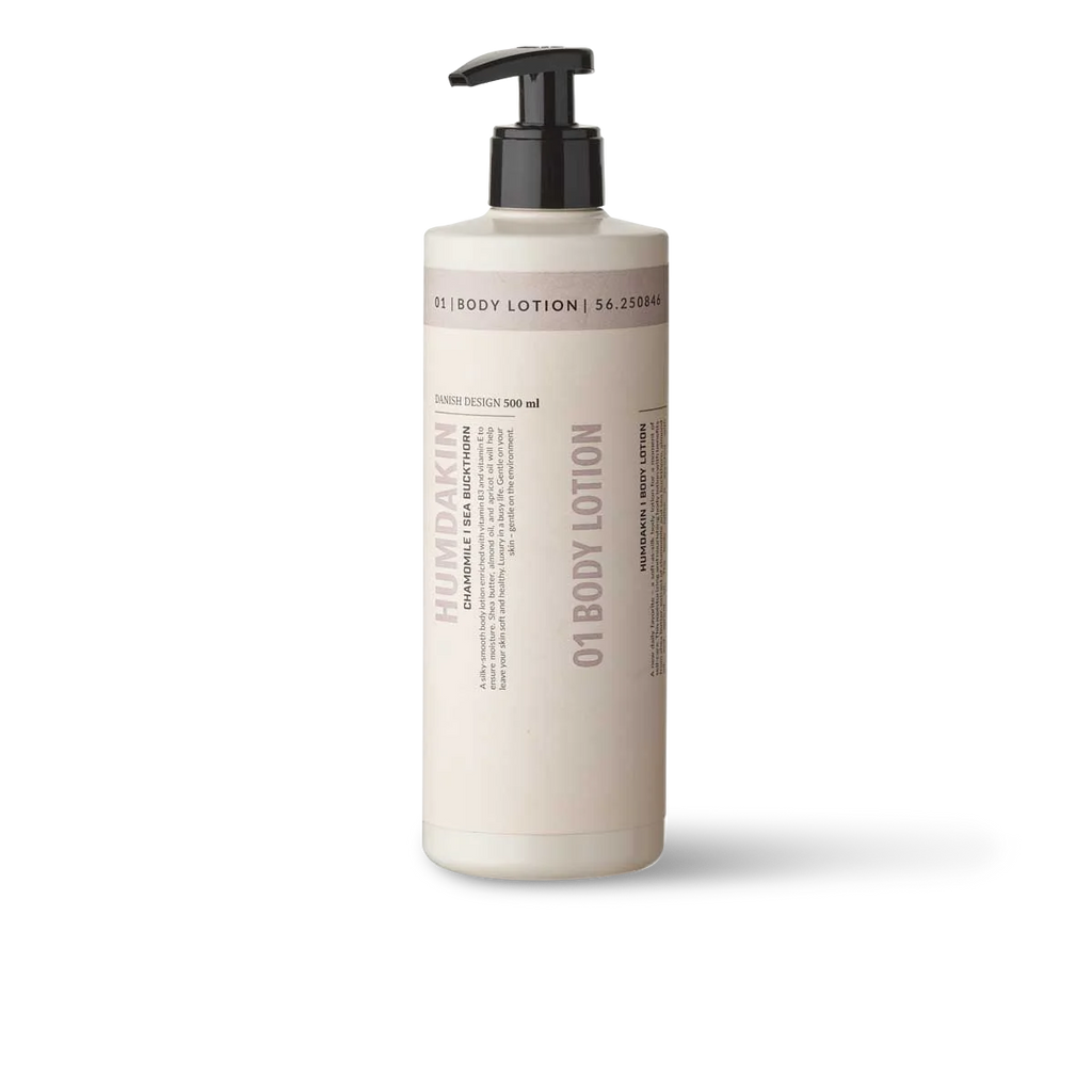 A bottle of Humdakin 01 BODY LOTION CHAMOMILE + SEA BUCKTHRON, a moisturizing skincare solution, on a white background.