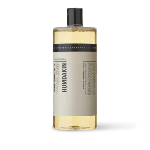 A bottle of HUMDAKIN 03 UNIVERSAL CLEANER WILD LEMONGRASS + NETTLE with a black background.