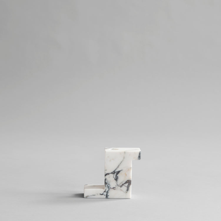 A small solid BRICK CANDLE HOLDER by 101 COPENHAGEN in a geometric shape.