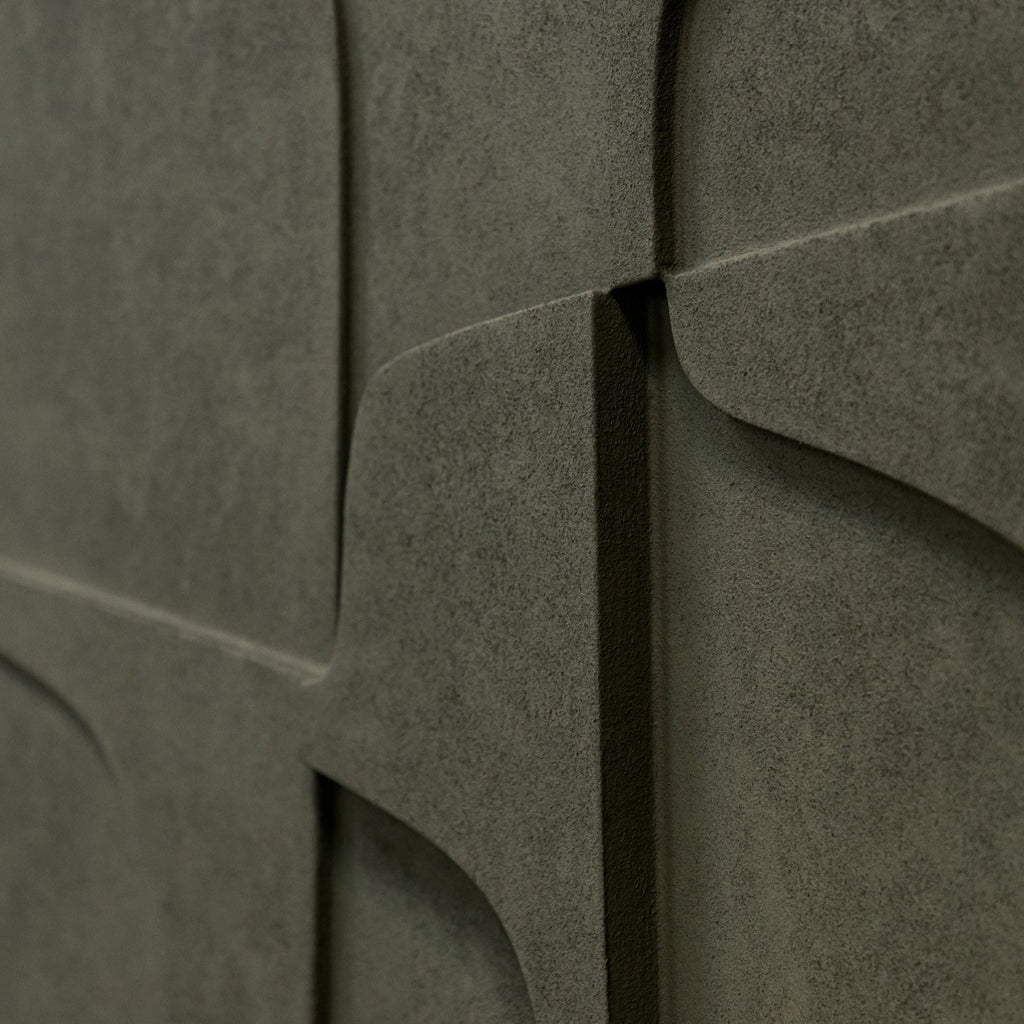 A close up of the ATELIER PLATEAU 07:23AM RELIEF, a limited edition gray wall with a pattern on it, showcasing color variations.