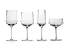 A set of four Dune glassware wine glasses by Kelly Wearstler on a white background.