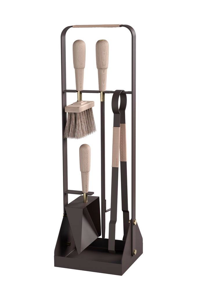 The Eldvarm Emma Fire Tool Companion Set is a collection of fire tools elegantly displayed in a metal stand.