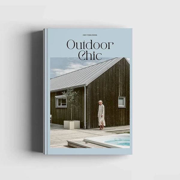 The cover of COZY Outdoor Chic magazine with a woman standing next to a pool.