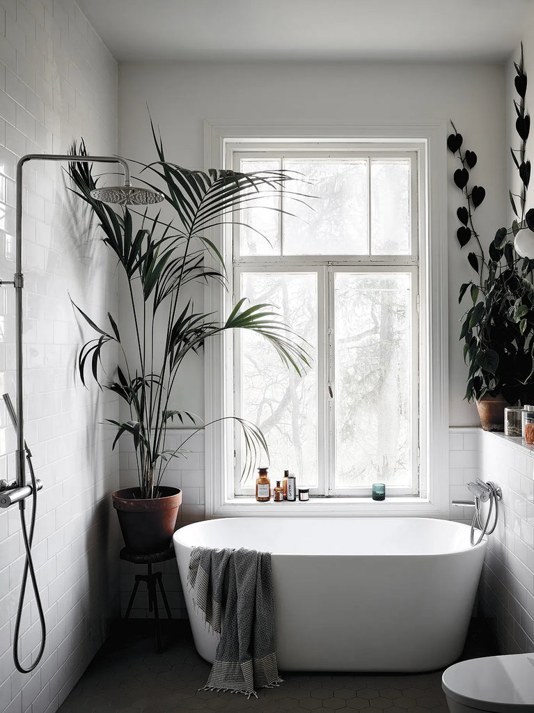 A HAPPY HOMES CREATIVE bathroom with plants and a tub from COZY.