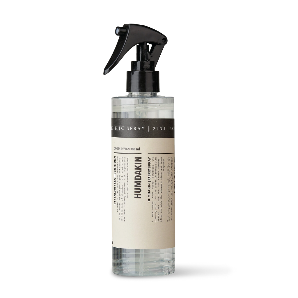 A sustainable fabric care spray, Humdakin Fabric Spray 2-in-1, featuring a white bottle and a black sprayer.