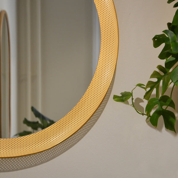 An ATBO FLORIS WALL MIRROR featuring an iconic design with a plant motif.