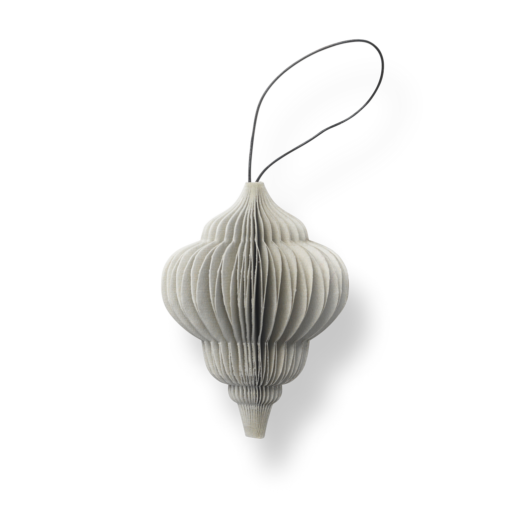 A NORDSTJERNE HOLIDAY ORNAMENT hanging from a string on a white background.