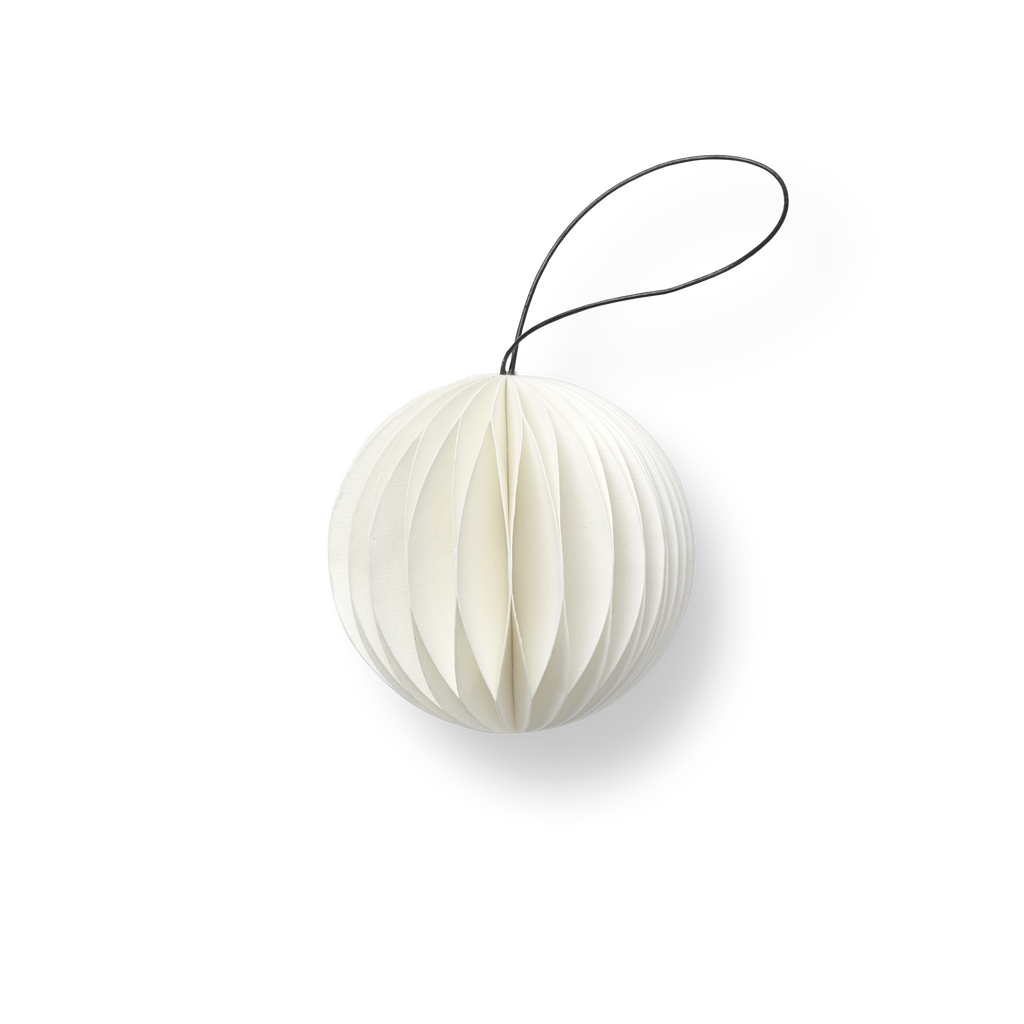 A white HOLIDAY ORNAMENTS ball hanging on a black cord from NORDSTJERNE.