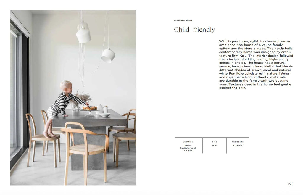 A page from the COZY magazine with a picture of a child in the NORDIC INTERIOR BOOK dining room.