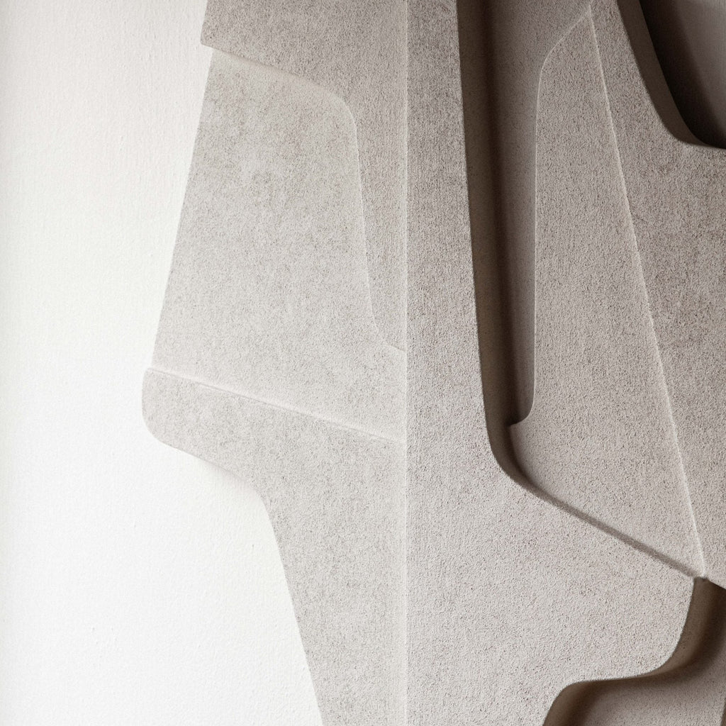 A limited edition sculpture, the PLATEAU 02:59 AM RELIEF by ATELIER PLATEAU, is displayed on an eco-friendly plaster white wall.