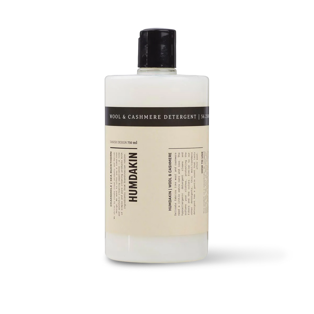 A bottle of HUMDAKIN WOOL + CASHMERE DETERGENT for natural fibers.