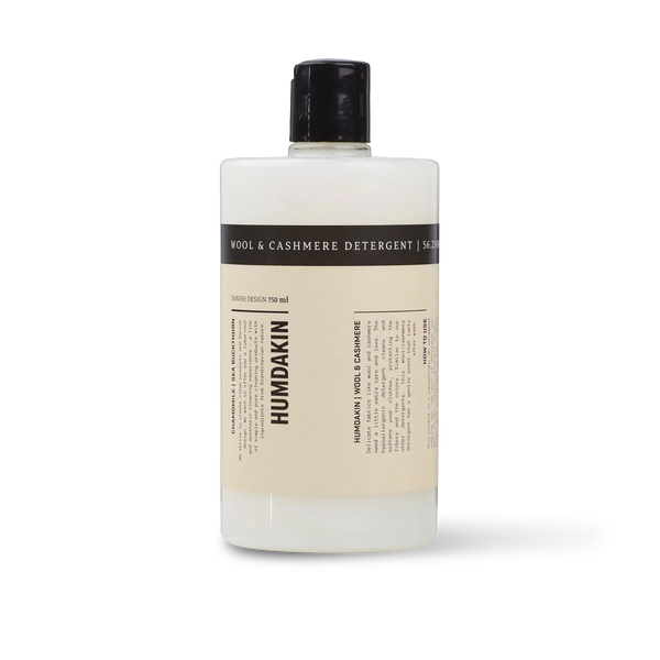 A bottle of HUMDAKIN WOOL + CASHMERE DETERGENT for natural fibers.