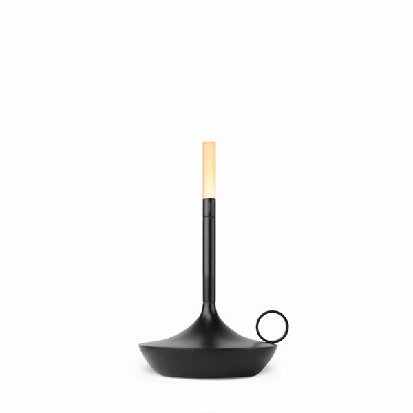 A WICK PORTABLE LAMP with a candle in it, made by GRAYPANTS.