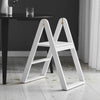 A white REECH STEPLADDER chair sitting on a wooden floor. (Brand: GEJST)