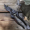 A pair of SECATEURS by BENSON on a wooden table.