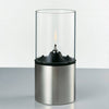 A STELTON EM OIL LAMP with a candle inside.