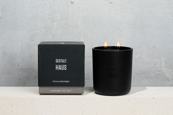 A SERIOUS MOONLIGHT CANDLE by GESTALT HAUS with a box next to it.