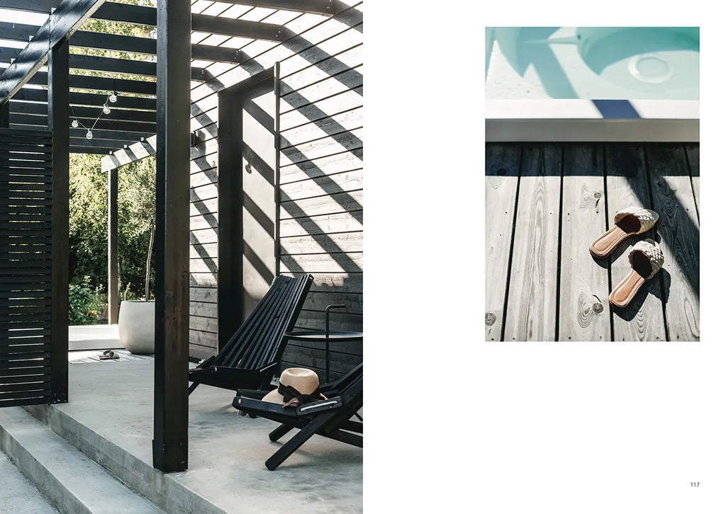 A black and white photo of an OUTDOOR CHIC wooden deck with chairs and a pool. (Brand: COZY)