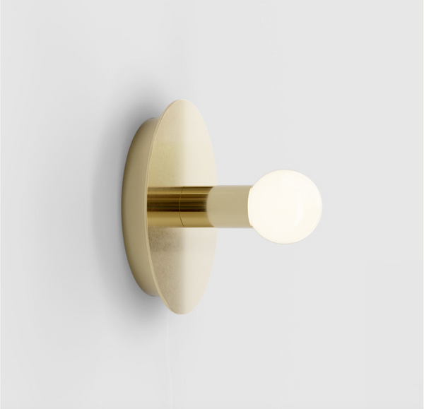 A DOT WALL LAMP by LAMBERT ET FILS illuminating a white wall at Gestalt Haus.
