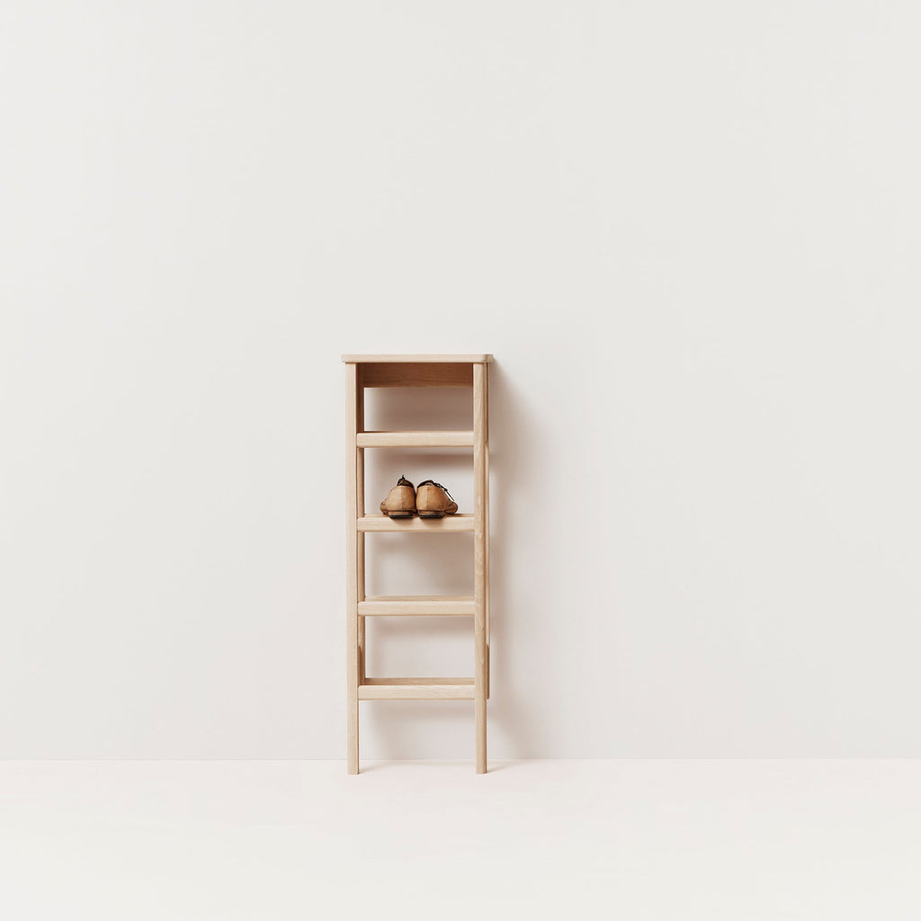 A FORM & REFINE LINE SHOE RACK 35 with two baskets on it.