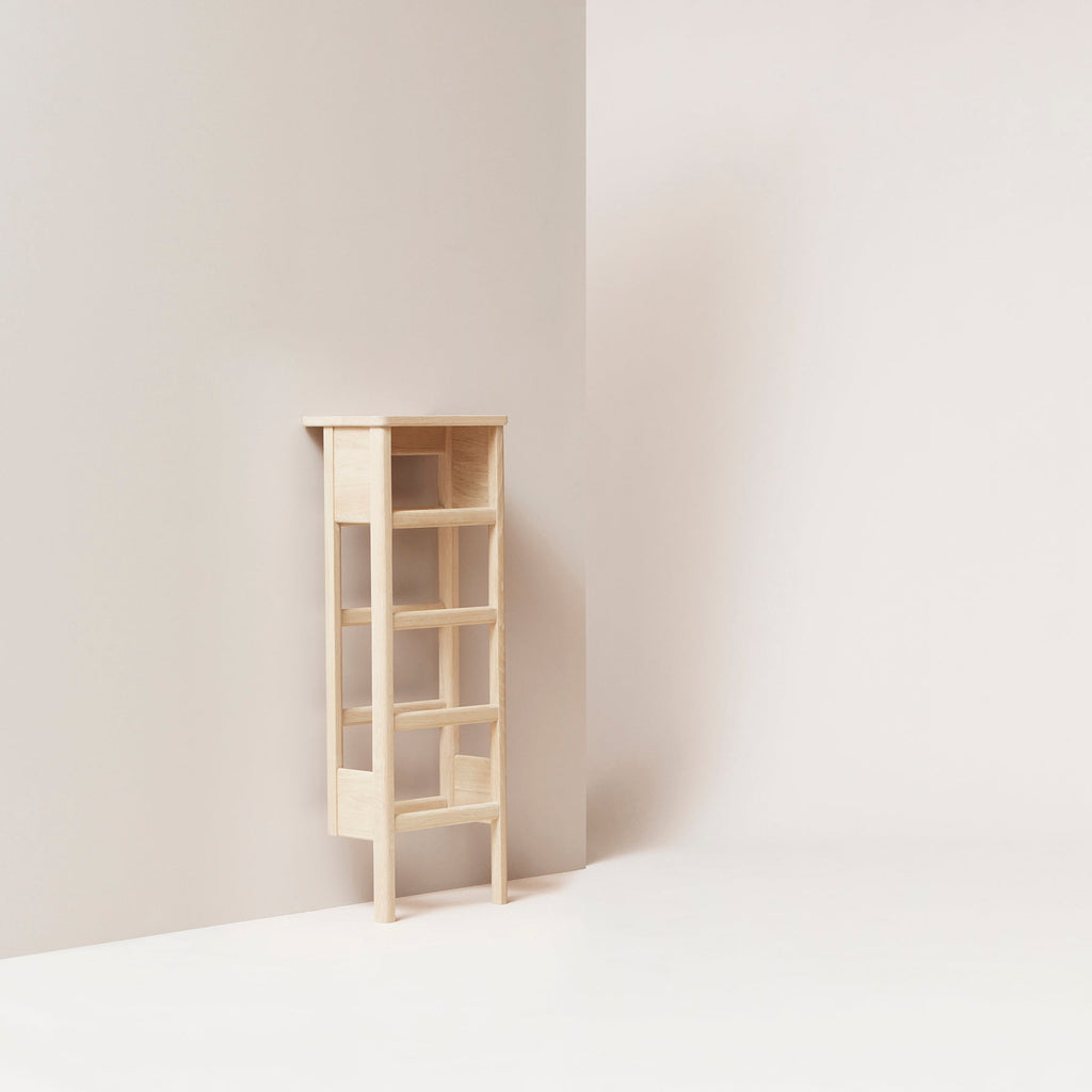 A FORM & REFINE LINE SHOE RACK 35 against a wall in a white room.