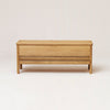 A FORM & REFINE LINE STORAGE BENCH 111 with a drawer on it.