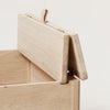 A FORM & REFINE LINE STORAGE BENCH 68 with a lid on it.