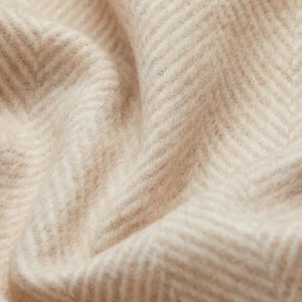 A close up of a SIBAST ALPACA HERRINGBONE THROW blanket featuring Gestalt Haus.