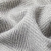 A close up image of a SIBAST ALPACA HERRINGBONE THROW fabric featuring Gestalt Haus inspiration.