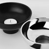 A black and silver ALUMINA TEALIGHT CANDLEHOLDER with a minimalist design from KRISTINA DAM STUDIO.