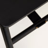 A close up of a Gestalt Haus black table with a gold handle.