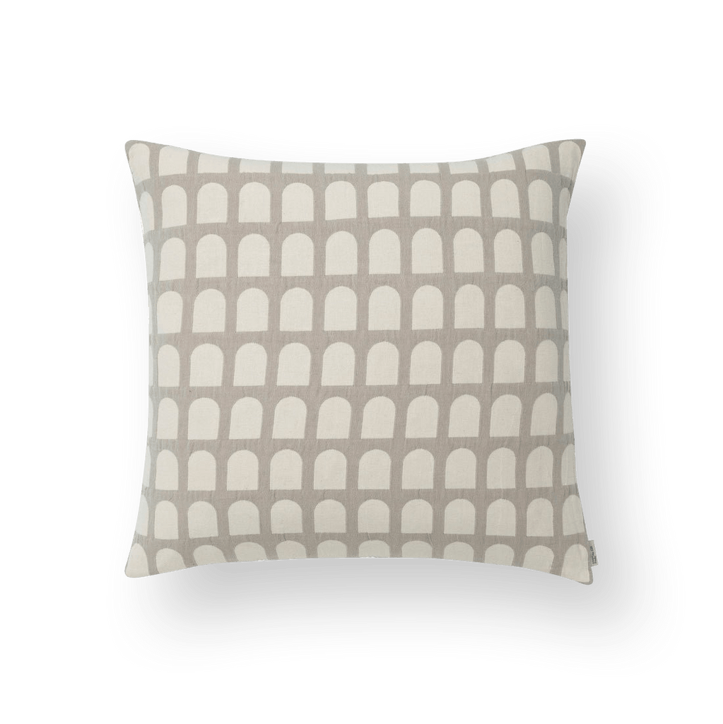 A ARCH CUSHION COVER with a geometric pattern in beige and white made by KRISTINA DAM STUDIO, inspired by the Gestalt Haus concept.