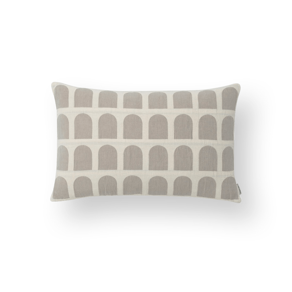 A KRISTINA DAM STUDIO ARCH CUSHION COVER with a Gestalt Haus-inspired arched design.