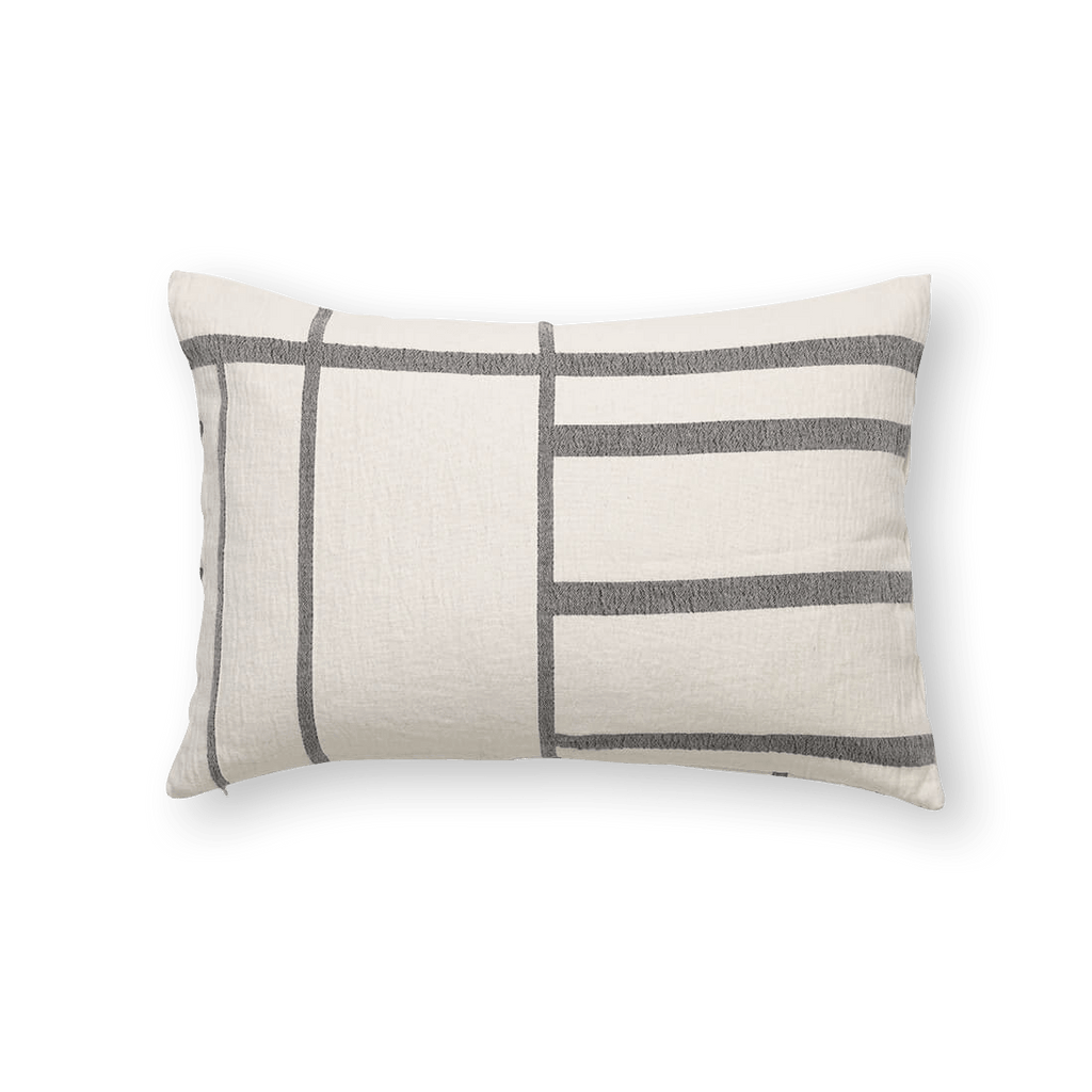 A Kristina Dam Studio ARCHITECTURE CUSHION with a black and white stripe, inspired by Gestalt Haus design.