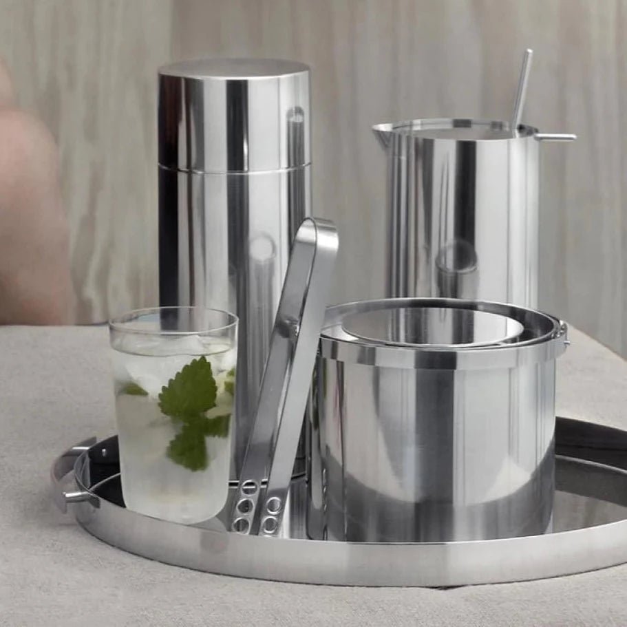 A STELTON silver tray with an ARNE JACOBSEN ICE TONGS on it, displayed at the Gestalt Haus.