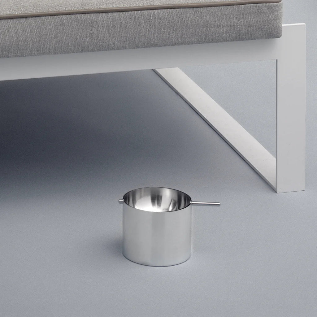 A STETLON ASHTRAY sitting next to a grey couch in a Gestalt Haus.