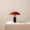 An IN COMMON WITH ARUNDEL LOW TABLE LAMP sits on a white table in a Gestalt Haus.