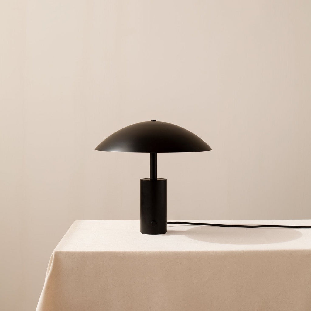 An ARUNDEL LOW TABLE LAMP by IN COMMON WITH on a white table in Gestalt Haus.