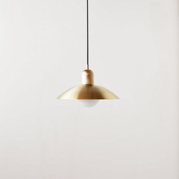 An ARUNDEL ORB PENDANT light hanging from a white wall in Gestalt Haus.