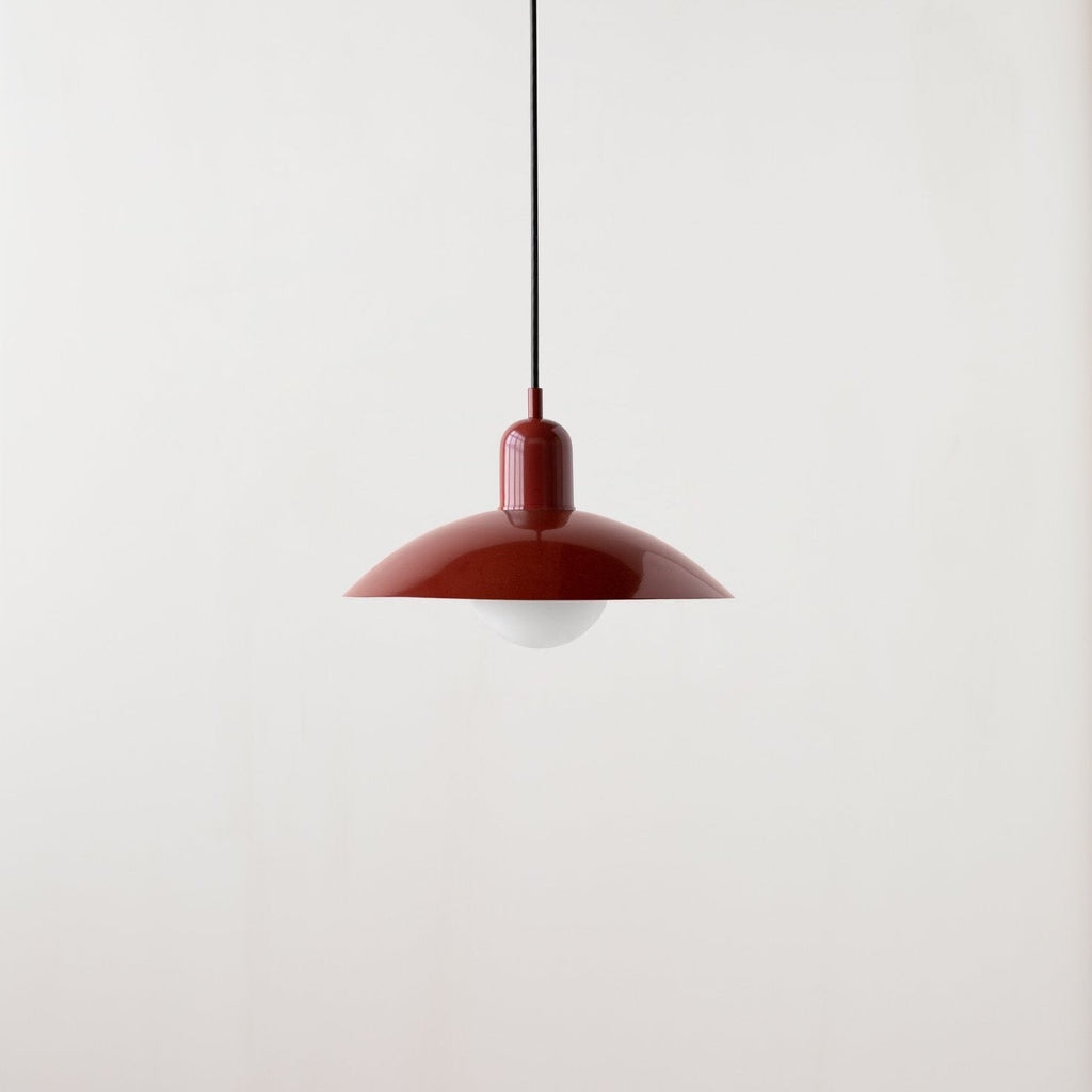 An Arundel Orb Pendant light hanging from a white wall at Gestalt Haus.