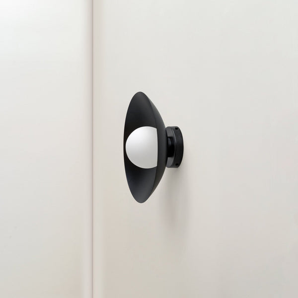 An IN COMMON WITH ARUNDEL ORB SURFACE MOUNT adorning a white wall in a Gestalt Haus.