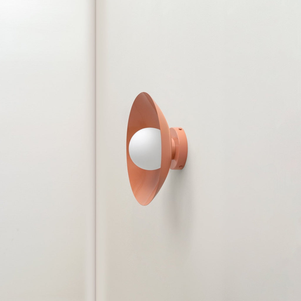 An ARUNDEL ORB SURFACE MOUNT by IN COMMON WITH Gestalt Haus wall light on a white wall.