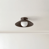 An Arundel Orb Surface Mount ceiling light in a room with a white ceiling, made by In Common With, at Gestalt Haus.
