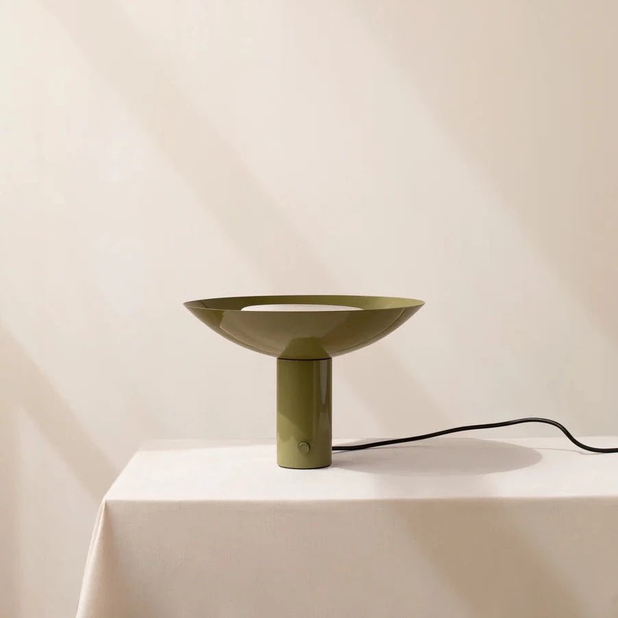 An ARUNDEL UP LIGHT by IN COMMON WITH on a table next to a white table at Gestalt Haus.