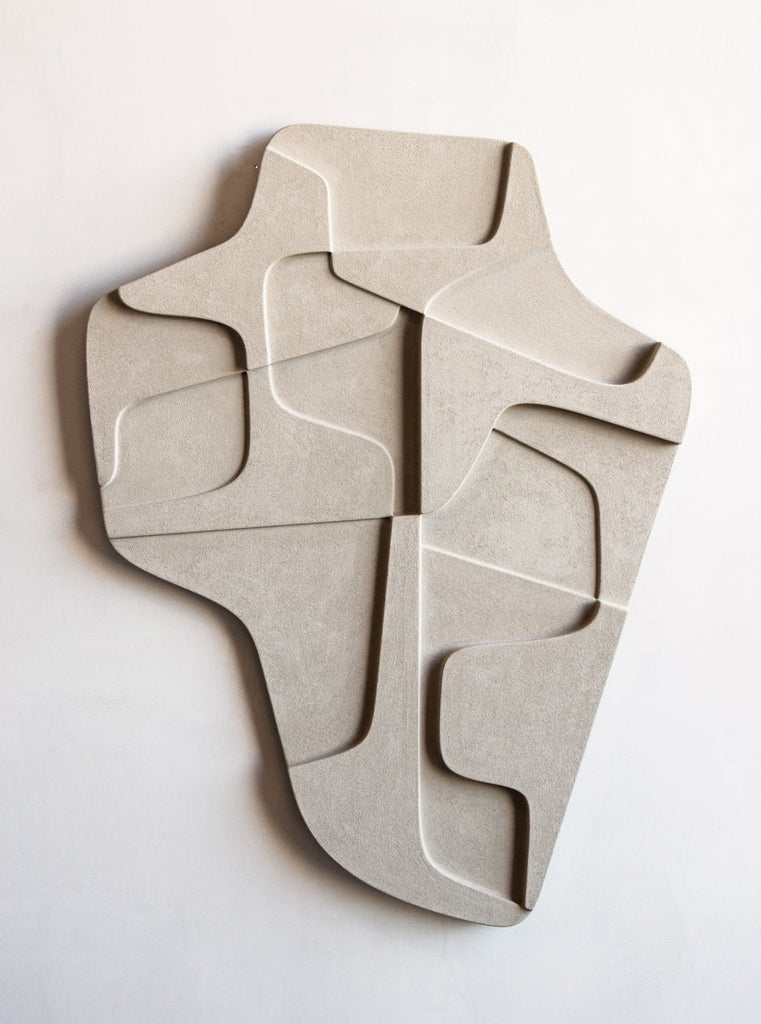 An ATELIER PLATEAU 04:15AM RELIEF sculpture made of concrete on a white wall at Gestalt Haus.