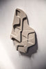 An ATELIER PLATEAU 04:15AM RELIEF sculpture made of concrete on a white wall, inspired by Gestalt.