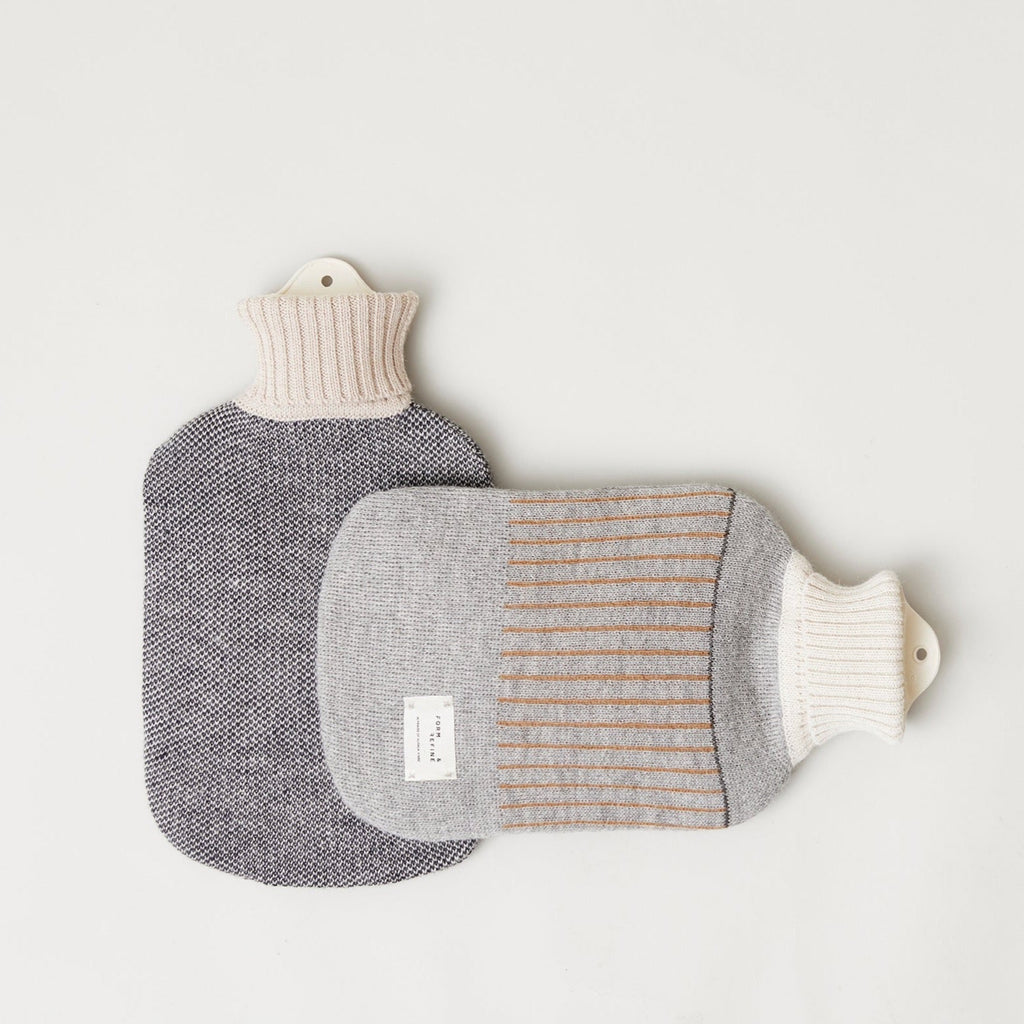 Two AYMARA hot water bottles by FORM & REFINE on a white surface.