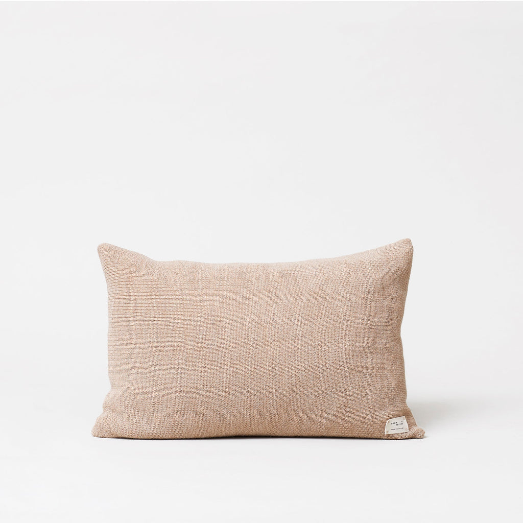 An AYMARA LONG CUSHION from FORM & REFINE with a Gestalt Haus twist on a white background.