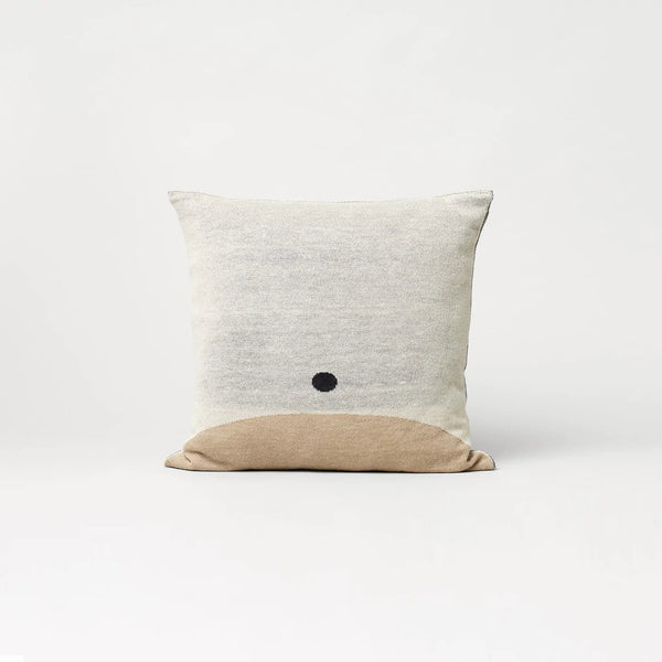 A bohemian AYMARA SQUARE CUSHION with a black dot on it, from FORM & REFINE at Gestalt Haus.